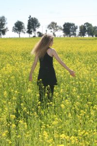 Woman recovering from eating disorder in a field